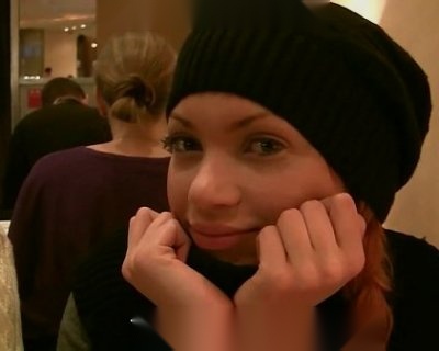 A bimbo in a knit cap is picking up money.