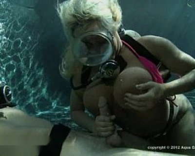 A slut in a swimsuit is holding her nipples.