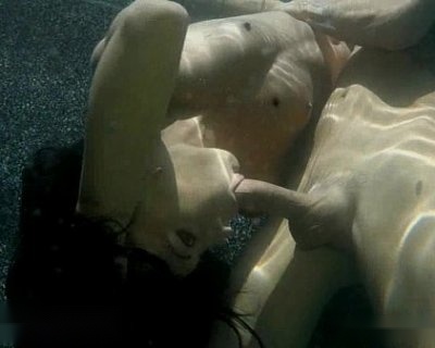 Two women with no shirts and one with a visible penis.