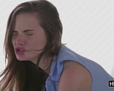 The girl is making a funny face and sticking out her tongue.