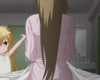 Women are standing next to each other. One of them is wearing a pink shirt and has long hair.