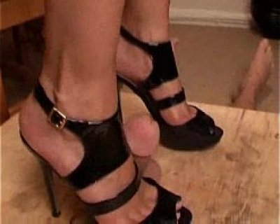 A slut is wearing high heels and black panties.