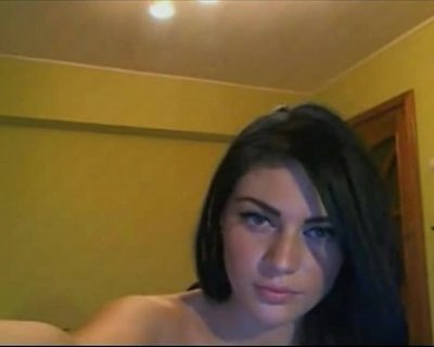 A bimbo in an unbuttoned shirt sits and makes a face.