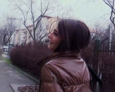A slut in a brown jacket looking at the camera.