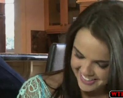 Smiling girl in front of kitchen cabinets. Brayhant Dillion Harper