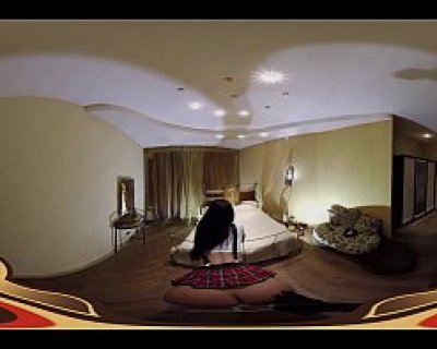 A bimbo with the name Dominatrix sits in front of a TV. Virtual Porn 360