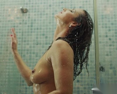 A slut is bathing in a shower and her hand touches her face. Xczech.Com