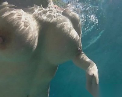 Olivia Austin swimming topless with large tits and freckles on her backside