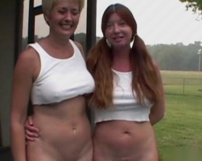 A bimbo with pigtails standing next to another bimbo with no shirt.