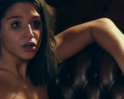 Abella Dangers face gets squished by a leather couch