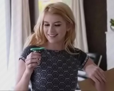 A teen girl smiles while she plays with her new glow-in-the-dark mini fidget spinner.