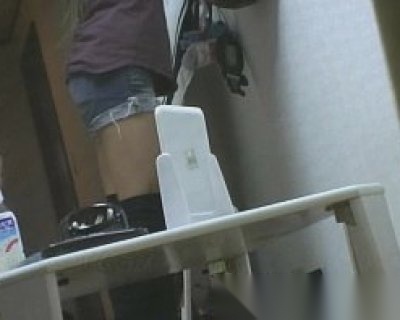 A slut is leaning against a table with an empty milk carton on it.