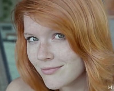 Luscious redhead enjoys her time under summers rays.