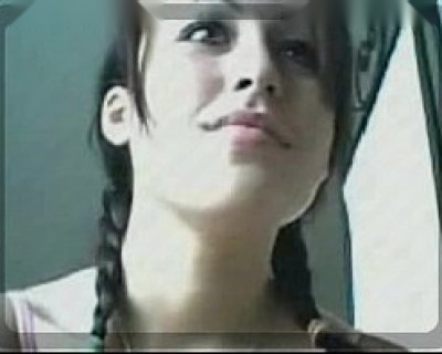 A girl is making a funny face while wearing a tie.