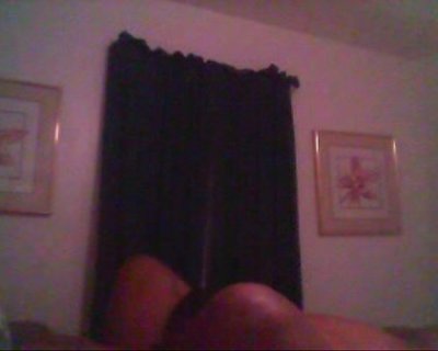 A person is laying on a chair with their back towards the camera.