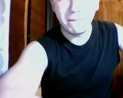 fucker with shaved hair wearing black and white tank top looking sad