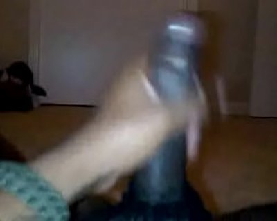 A person is boxing with something. It appears to be a sex toy.