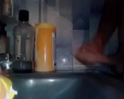 A person is stepping inside a bathtub.
