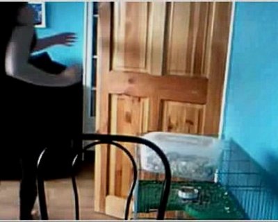 The person in black has on a white shirt and is waving.