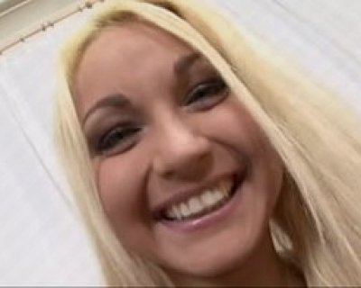 Blond girl smiling and wearing makeup