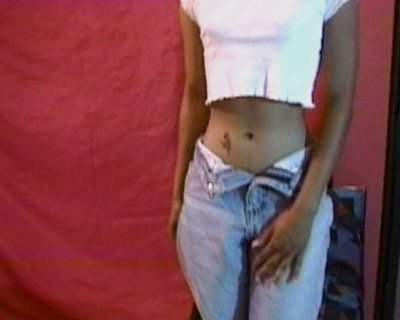 The lady shows off her belly button. Photographed by African Angels.