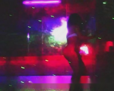 A dancing bimbo in front of disco lights.