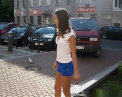 A girl in blue shorts is walking. The photo is blurry.
