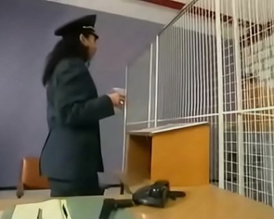 The cop is holding a cup. The cup is next to him.