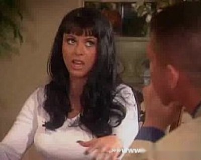 A whore is pointing. Her hair is black and long.