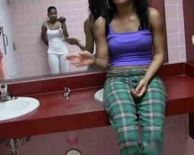 The whore sitting at the sink is wearing a purple shirt.
