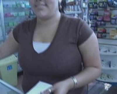 A bimbo holding paper in front of her. The bimbo is wearing a brown shirt.