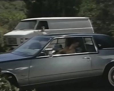 A male in back is pulling the shirt off the whore in front.
