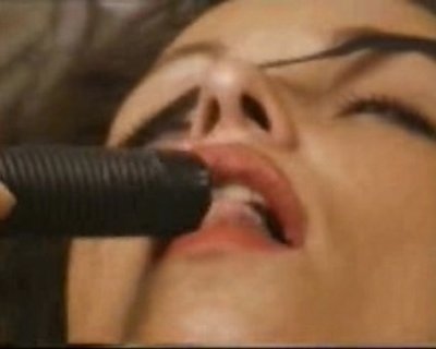 A lady kisses a device. (Censored.)