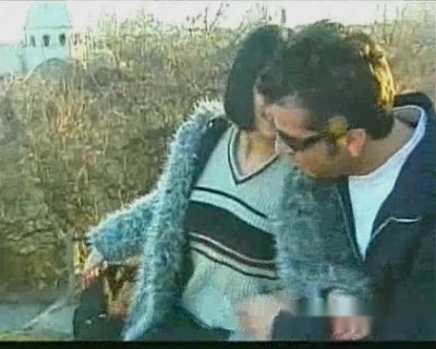 A man and slut are standing in front of a building.