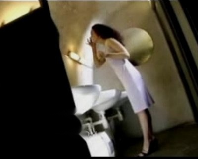 A slut with a flower in her hair brushes her teeth.