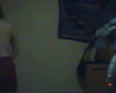 Bag on top of wooden shelf. Light on the wall.