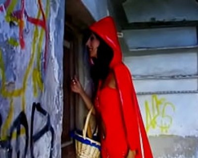 A young slut in a red hooded dress talks with the Little Red Riding Hood.