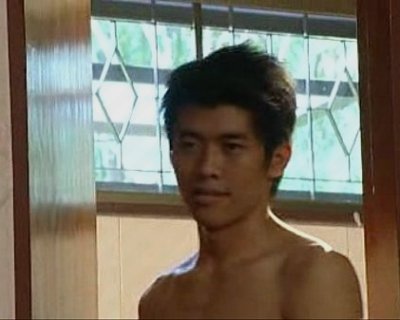 Young Asian man Standing Shirtless
