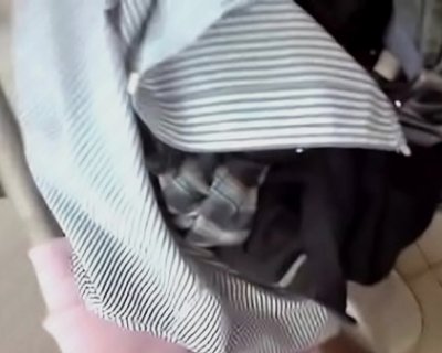 A shirt is hanging from the washer.