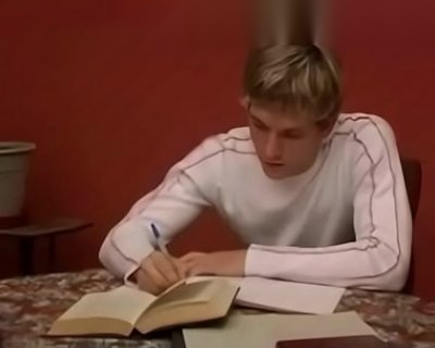 A boy writing with pencil