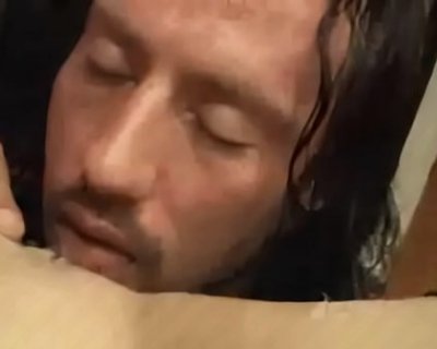A man with long hair sleeping