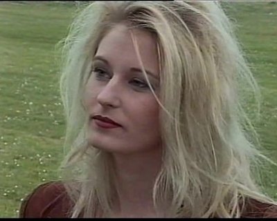 The young slut is making a face. She is wearing lipstick.