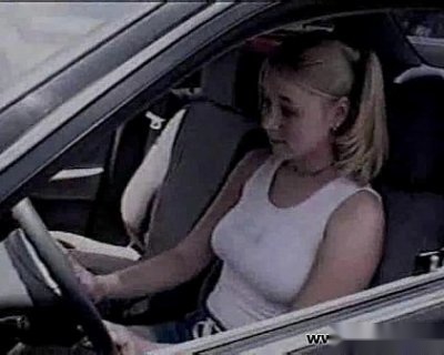A slutty bimbo sitting in a car